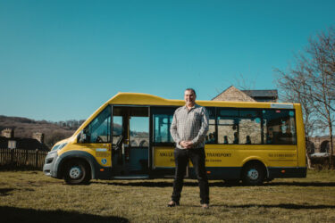 Denby Dale Centre, Paul Jones Mbe standing in front of the mini bus